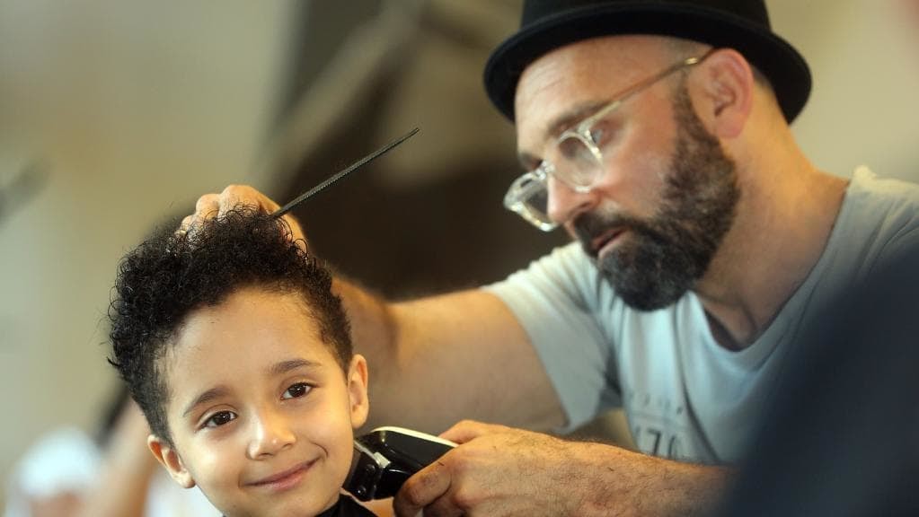 Molendinar boy Izaiah Smith gets his curly locks of hair cut for charity and loves his do